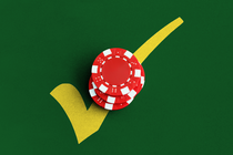 Red poker chips on top of a yellow check mark