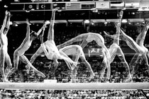 A series of freeze-frames of a gymnast performing a flip