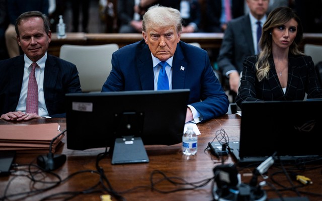 Trump seated next to his lawyers