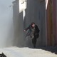 A man runs from dust that followed an attack on a Shiite cultural center in Kabul in 2017.