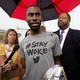 DeRay Mckesson speaks to the media, wearing a grey shirt that says 'Stay Woke.'