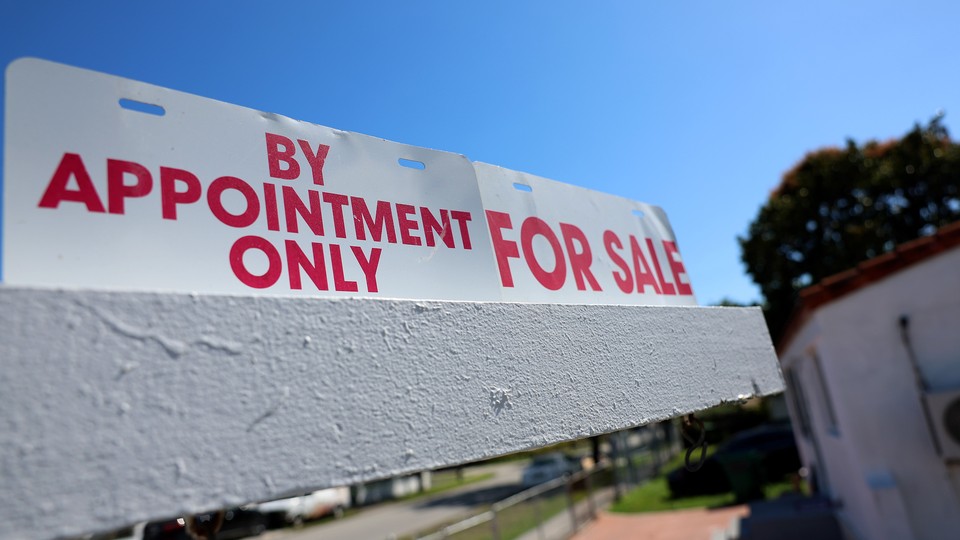 A real-estate sign is displayed in front of a home on February 22, 2023, in Miami, Florida.