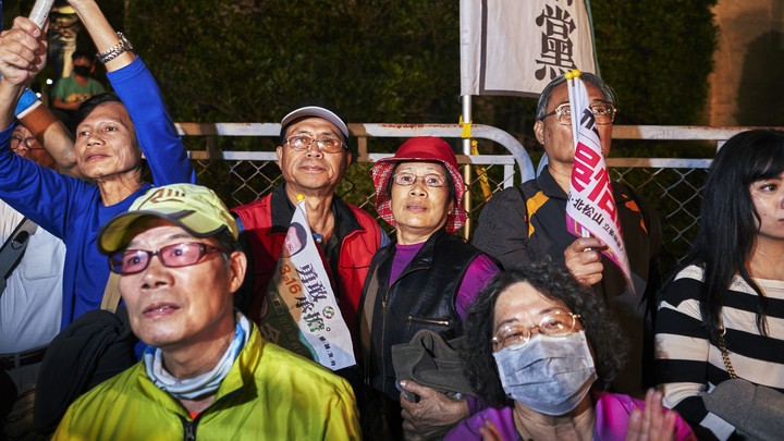 People wait for election results in Taiwan.