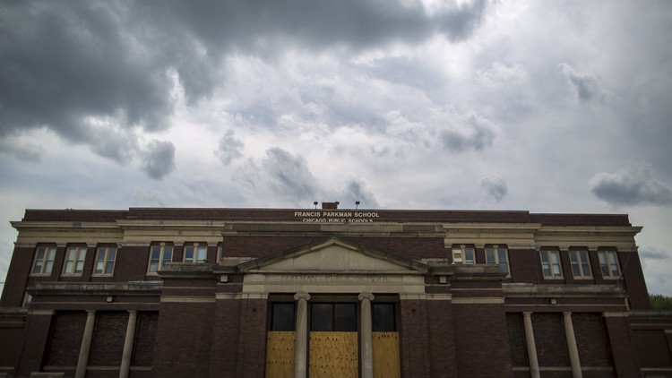 An abandoned, boarded up building in Chicago that two years before this photo was taken housed a school that was later closed