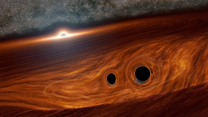 Artist’s concept of a supermassive black hole and its surrounding disk of gas, with two smaller black holes embedded within