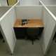An empty office cubicle with an unplugged phone