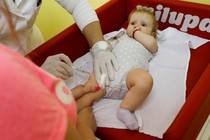 A baby receives a vaccine injection.