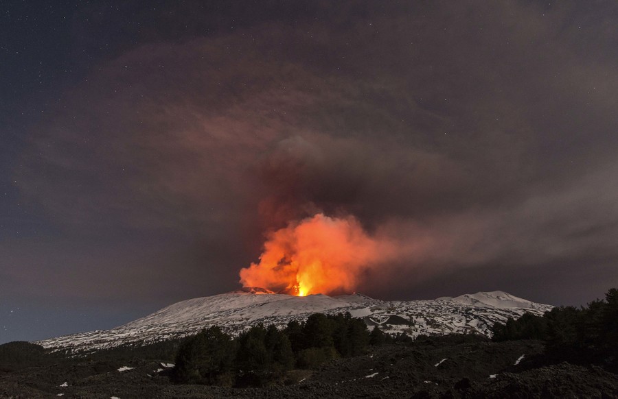 Snow-covered Mount Etna spews lava during an eruption in the early hours of March 16, 2017.