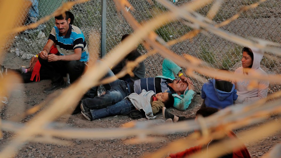 Migrants being held by U.S. Customs and Border Protection (CBP), after crossing the border between Mexico and the United States illegally and turning themselves in to request asylum, in El Paso, Texas, on March 29, 2019