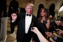 President-elect Donald Trump speaks to reporters as his wife, Melania, looks on.