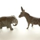 Two figurines of a donkey and an elephant