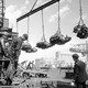Workers unload finished engines at Ford’s River Rouge plant in 1937.