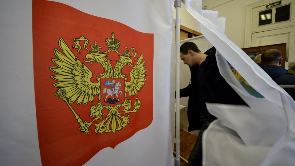 A man enters a polling booth in Russia's 2018 presidential elections.