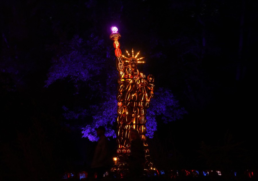 A replica of the Statue of Liberty made of illuminated pumpkins