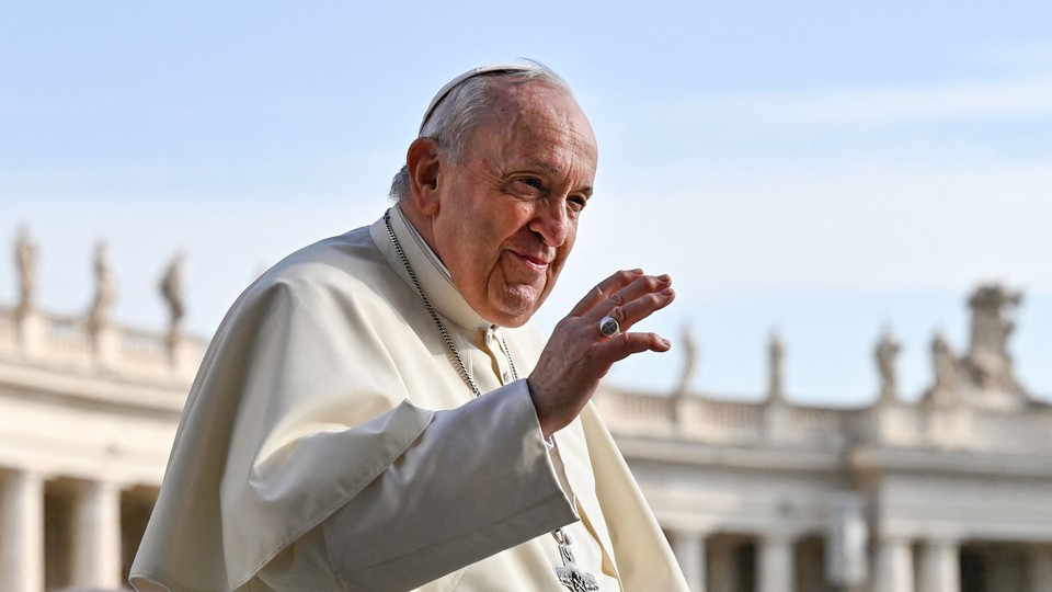 Pope Francis waves.