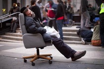 A protestor affiliated with the Occupy Wall Street movement falls asleep in an armchair in Foley Square in 2011. 