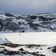 A figure walking in the snow