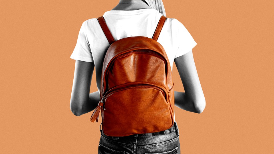 A woman wearing an orange backpack
