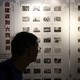 Visitors look at photographs at the June 4 Museum in Hong Kong during its reopening event in April.