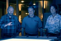 Matthew Maher, Matt Damon, and Jason Bateman, cast in blue light, look at an image proof in the movie "Air"