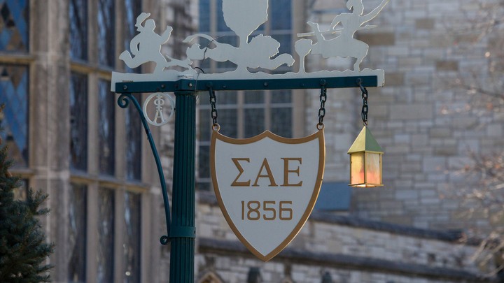 A sign on a lamppost with the initials of Sigma Alpha Epsilon on it