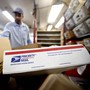 A mailman carrying several USPS packages