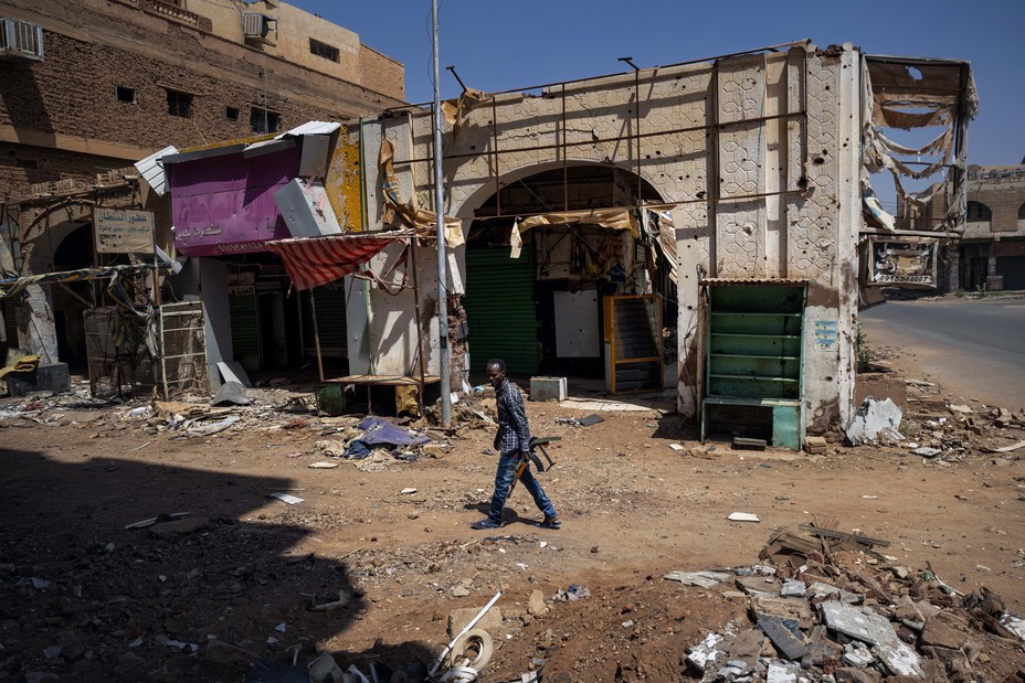 A man walks among a destroyed street