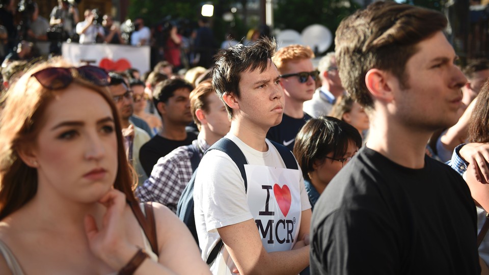 People attend a vigil in Albert Square in Manchester on May 23, 2017.