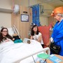 Queen Elizabeth II speaks to Amy Barlow, 12, from Rawtenstall, Lancashire, and her mother, Kathy, during a visit to the Royal Manchester Children's Hospital in Manchester, Britain, on May 25. 