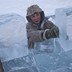 A man loads blocks of ice onto a truck outside Yakutsk