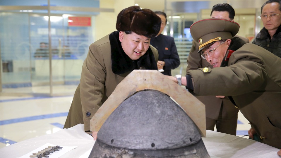 North Korean leader Kim Jong Un looks at the tip of a rocket warhead after a simulated test of atmospheric reentry of a ballistic missile.