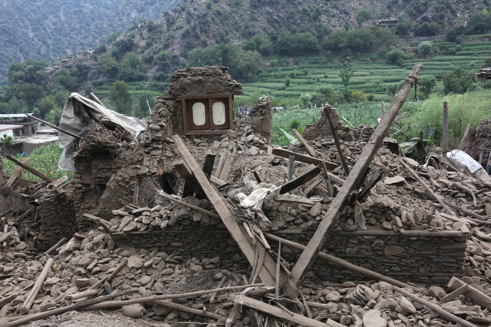 A pile of rocks and timber that used to be a house, toppled by an earthquake.