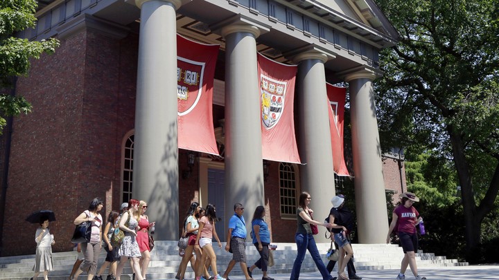 A campus tour walks through the Harvard campus.