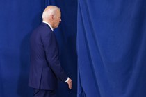 A photo of Biden leaving a stage