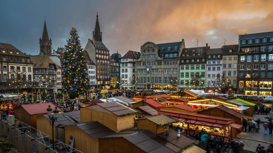 An overview of a traditional Christmas market in a city square in France