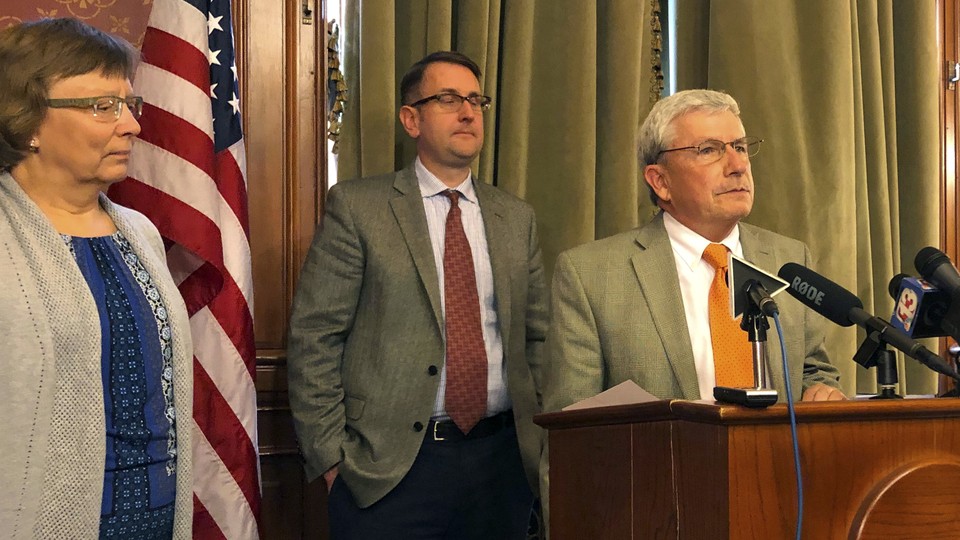 Andy McKean, right, the longest-serving Republican in the Iowa legislature, announced that he's becoming a Democrat during a news conference on April 23, 2019.