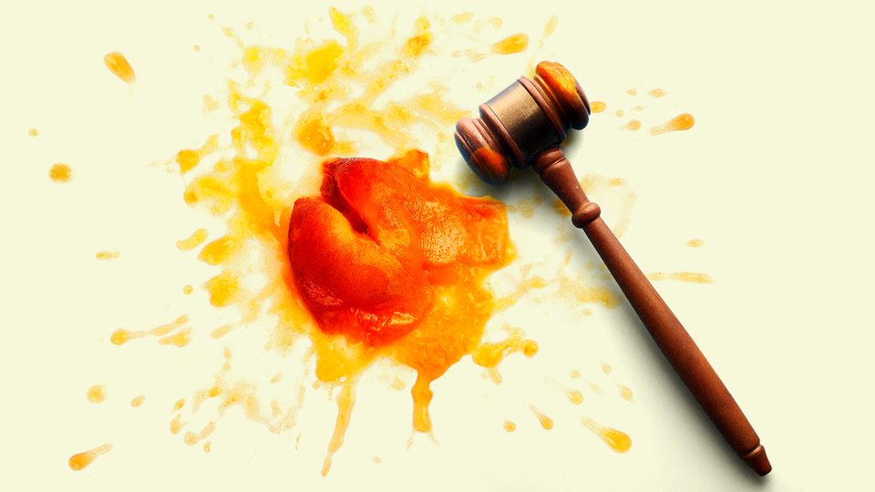 A judge's gavel next to a smashed peach