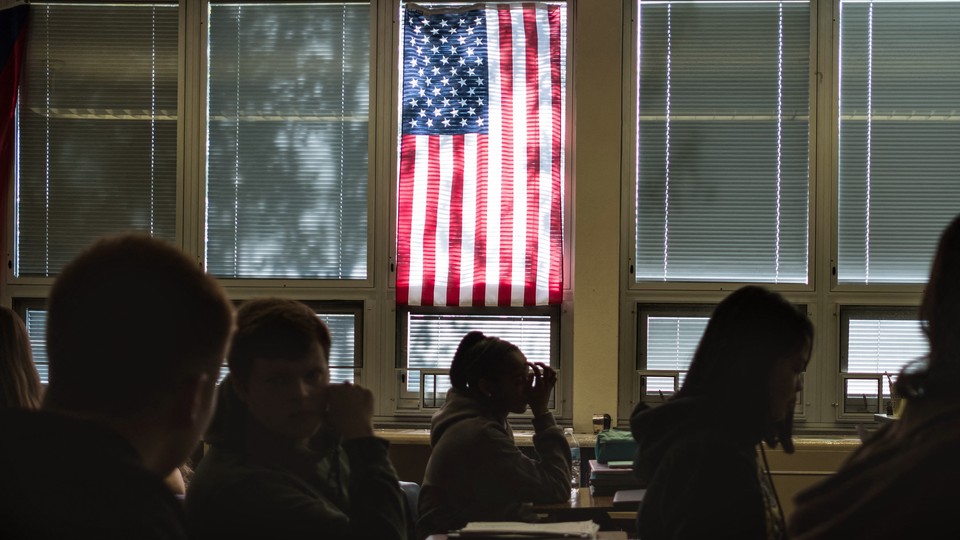 Picture of a classroom with an American flag in the background