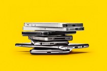 A photograph of several smartphones stacked on top of one another