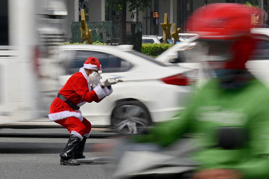 An officer dressed as Santa Claus directs traffic.