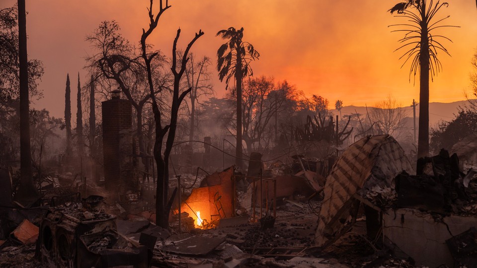 LA during the fire: The sky is orange, palm trees singled, and in the remains of a house a flame is still burning