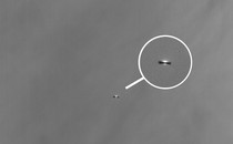 A black-and-white view of a planetary system in the making from afar, captured by the James Webb Space Telescope