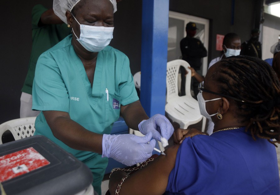 A woman receives a vaccine shot.