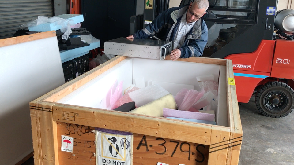 Shipping manager Don Sousa opens an important shipment from Antarctica.