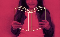 a child holds the outline of a book