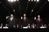 Three representatives, of Google, Facebook, and Twitter, stand with their right hands raised to be sworn in for the Senate Intelligence Committee hearing on Russia's election activity