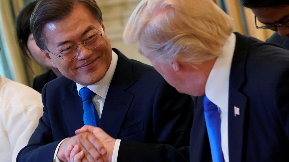 Donald Trump shakes hands with South Korean President Moon Jae-in.