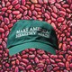 A green MAHA hat surrounded by beans