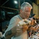 Anthony Bourdain holding part of a sandwich
