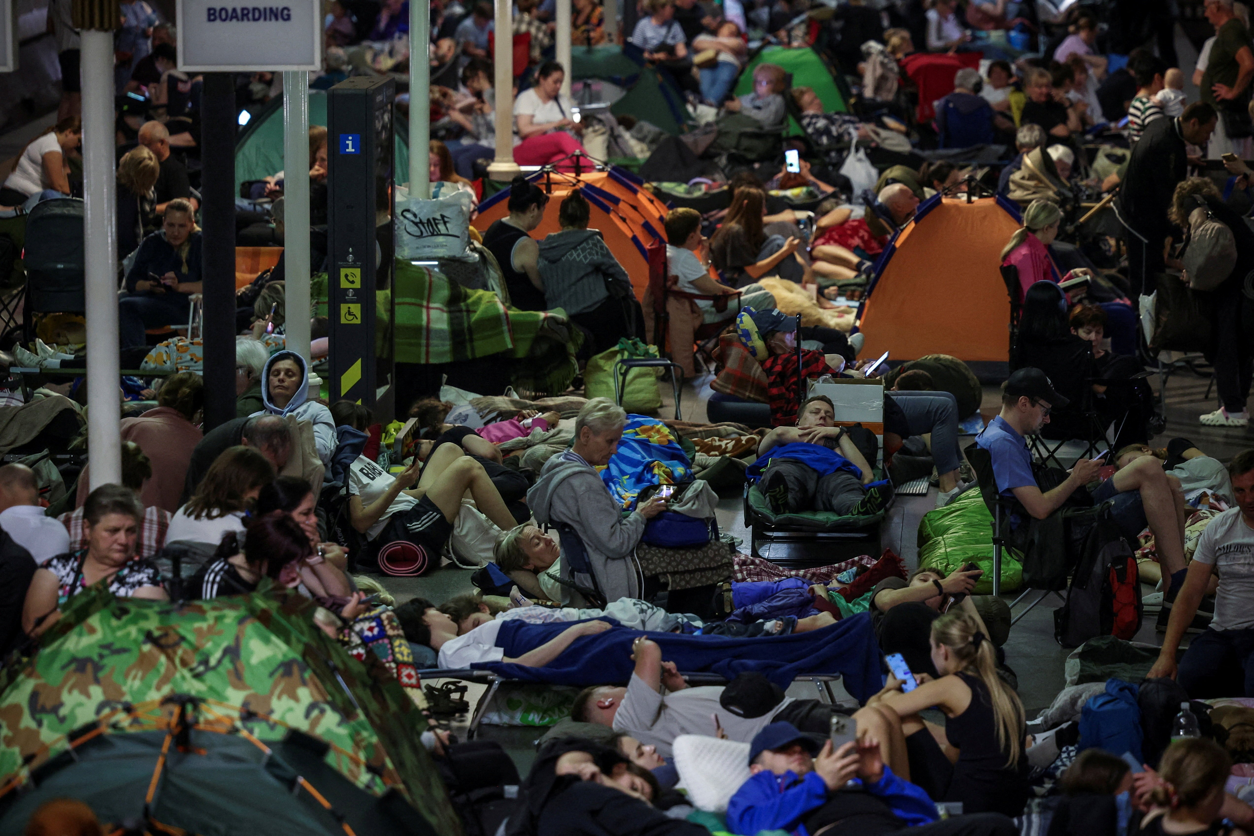 Many people take shelter inside a metro station during an overnight missile and drone strike.